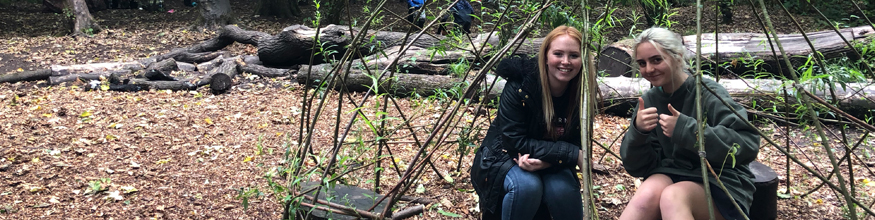 students smiling in the woods